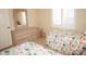 Bright bedroom with twin beds, a dresser, and shuttered windows at 3398 Tripoli Blvd, Punta Gorda, FL 33950