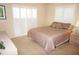 Comfortable bedroom with a queen-sized bed, neutral tones, and shuttered windows at 3398 Tripoli Blvd, Punta Gorda, FL 33950
