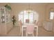 Elegant dining room featuring a glass-top table, pink chairs, and a bright window with shutter at 3398 Tripoli Blvd, Punta Gorda, FL 33950