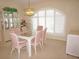 Formal dining room with a glass table, pink chairs, and a large window with shutters at 3398 Tripoli Blvd, Punta Gorda, FL 33950