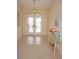Bright foyer features tiled floors, a glass table with flowers and a view of the double door entrance at 3398 Tripoli Blvd, Punta Gorda, FL 33950