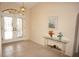 Elegant foyer with tile flooring, glass table and a view of the front doors at 3398 Tripoli Blvd, Punta Gorda, FL 33950