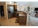 Open-concept kitchen featuring stainless steel appliances, marble countertops, and an eat-in bar area at 3398 Tripoli Blvd, Punta Gorda, FL 33950