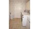 Functional laundry room with washer, dryer, storage cabinet, and neutral color scheme at 3398 Tripoli Blvd, Punta Gorda, FL 33950