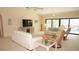 Bright living room featuring plush seating, a large TV, and sliding glass doors to the pool area at 3398 Tripoli Blvd, Punta Gorda, FL 33950