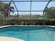 Screened in pool with water views, mature landscaping and several neighborhood properties at 3398 Tripoli Blvd, Punta Gorda, FL 33950