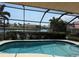 Heated, screened in pool with canal views and mature landscaping in a tropical community at 3398 Tripoli Blvd, Punta Gorda, FL 33950