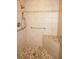 Accessible walk-in shower features tiled walls, a mosaic floor, and grab bars for safety and comfort at 3398 Tripoli Blvd, Punta Gorda, FL 33950