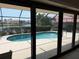 The view from the sliding glass doors looks out to the pool, a canal and beautiful neighboring homes at 3398 Tripoli Blvd, Punta Gorda, FL 33950