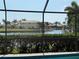An idyllic canal view from the home, framed by lush greenery and neighboring properties, inviting tranquility at 3398 Tripoli Blvd, Punta Gorda, FL 33950
