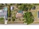 Aerial view of a home with a screened in pool, storage shed and lush landscaping at 4071 Dekle Ave, North Port, FL 34286