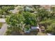 An aerial view of the home with mature trees and a long driveway at 4071 Dekle Ave, North Port, FL 34286
