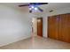 Bedroom has wood closet doors, neutral-colored walls and tiled floors at 4071 Dekle Ave, North Port, FL 34286
