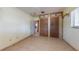 A cozy bedroom features a tiled floor, neutral paint and a sizable closet area at 4071 Dekle Ave, North Port, FL 34286