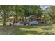 Home exterior with a lawn, mature landscaping and a driveway at 4071 Dekle Ave, North Port, FL 34286