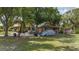 Home exterior with a lawn, mature landscaping and a driveway at 4071 Dekle Ave, North Port, FL 34286