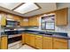 Bright kitchen with wooden cabinets, updated stainless steel appliances, and ample counter space at 4071 Dekle Ave, North Port, FL 34286