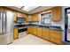 Kitchen featuring wood cabinets, stainless steel appliances, tile backsplash, and a view to the pool at 4071 Dekle Ave, North Port, FL 34286