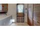 Functional laundry room with washer, dryer, ample storage, and access to the outdoors at 4071 Dekle Ave, North Port, FL 34286