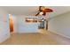 Bright living room featuring tile flooring, a modern ceiling fan, and views into the kitchen and lanai at 4071 Dekle Ave, North Port, FL 34286