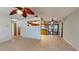 Spacious living room with tile floors, ceiling fans, and a view of the kitchen through a pass-through window at 4071 Dekle Ave, North Port, FL 34286