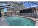 Relaxing screened-in pool featuring steps for entry, a safety fence and view of the yard at 4071 Dekle Ave, North Port, FL 34286