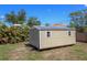 Tan storage shed with a metal roof and plenty of space for your tools and toys at 4071 Dekle Ave, North Port, FL 34286