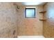 Tiled shower and bath with window and two shelves at 4071 Dekle Ave, North Port, FL 34286