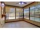 Bright sunroom with tiled floors, pendant lighting and multiple windows overlooks the pool area at 4071 Dekle Ave, North Port, FL 34286