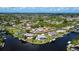 Aerial view of waterfront community, with docks, mature trees, and lush landscaping at 4216 Bur St, Port Charlotte, FL 33948