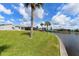 Manicured lawn leading to a waterfront view, lush tropical landscaping at 4216 Bur St, Port Charlotte, FL 33948