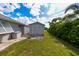A backyard featuring a storage shed and green lawn at 4216 Bur St, Port Charlotte, FL 33948