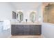 Bright bathroom with double vanity, large mirrors, and a walk-in shower at 4216 Bur St, Port Charlotte, FL 33948