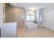 Modern bathroom with a stand-alone tub, walk-in shower, and bright lighting at 4216 Bur St, Port Charlotte, FL 33948