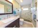 Stylish bathroom with marble vanity, updated sink and frameless glass shower with pebble floor at 4216 Bur St, Port Charlotte, FL 33948