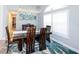 Bright dining room with stylish wooden table, decorative rug, and plenty of natural light at 4216 Bur St, Port Charlotte, FL 33948