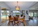 Well-lit dining area showcases a view of the pool, adjacent to comfortable living spaces at 4216 Bur St, Port Charlotte, FL 33948