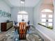Elegant dining room with modern chandelier, large window and designer rug at 4216 Bur St, Port Charlotte, FL 33948