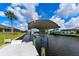 Waterfront property featuring a private boat dock with lift at 4216 Bur St, Port Charlotte, FL 33948