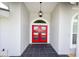 Front entrance featuring a bright red double-door, black tile, and a modern hanging light fixture at 4216 Bur St, Port Charlotte, FL 33948
