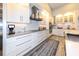 Modern kitchen with stainless steel appliances, white cabinetry, and a stylish backsplash at 4216 Bur St, Port Charlotte, FL 33948