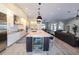 Bright, open-concept kitchen features a large center island, modern appliances, and seamless flow to living area at 4216 Bur St, Port Charlotte, FL 33948