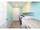 A laundry room with white cabinets, marble countertops, and modern washer and dryer at 4216 Bur St, Port Charlotte, FL 33948