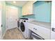 A laundry room with white cabinets, marble countertops, and modern washer and dryer at 4216 Bur St, Port Charlotte, FL 33948