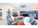 Bright living room with comfortable seating, modern ceiling fan, and view of the lanai and pool at 4216 Bur St, Port Charlotte, FL 33948