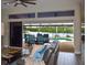 Living room showcases sliding glass doors opening to a covered patio, pool, and waterfront view at 4216 Bur St, Port Charlotte, FL 33948