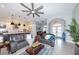 Open-concept living room features an archway, modern fan, and seamless flow to the kitchen area at 4216 Bur St, Port Charlotte, FL 33948