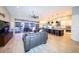 Spacious open-concept living room featuring a modern kitchen, leather sofas, and water views at 4216 Bur St, Port Charlotte, FL 33948