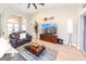 Open living room with tiled floors, palm tree accent, and large screen TV in a modern setting at 4216 Bur St, Port Charlotte, FL 33948