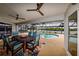 The home features a covered patio with comfortable seating, ceiling fans, and access to the pool at 4216 Bur St, Port Charlotte, FL 33948